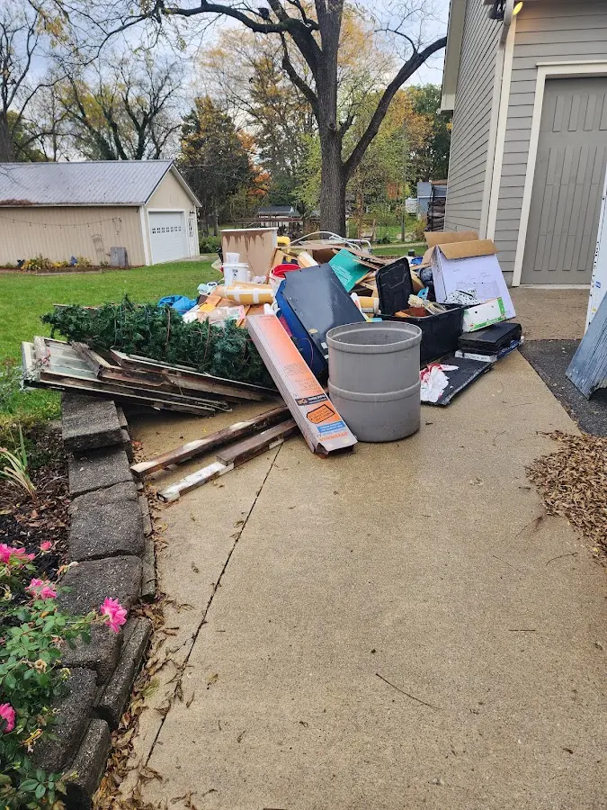 Dumpster being loaded with debris for Estate Cleanout Dumpster Rental in West Pennsboro